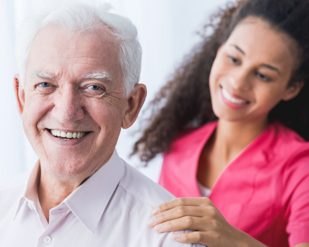 Picture of happy positive senior and caregiver