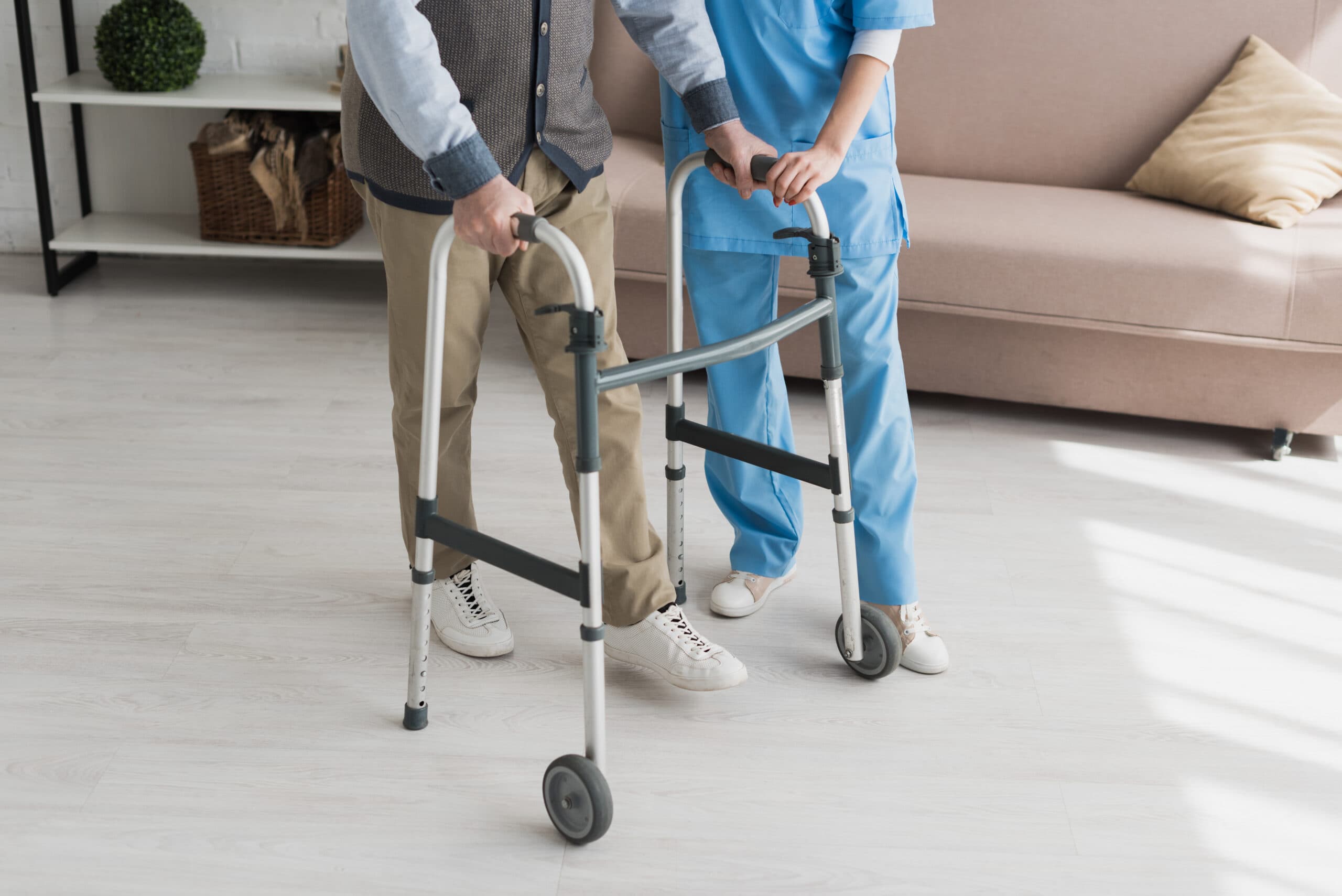 home caregiver and elderly person with walker